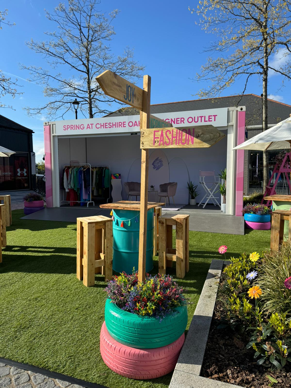 Gallery Plus shipping container conversion product graphic wrapped in bold pink design for Cheshire Oaks designer outlet popup retail event