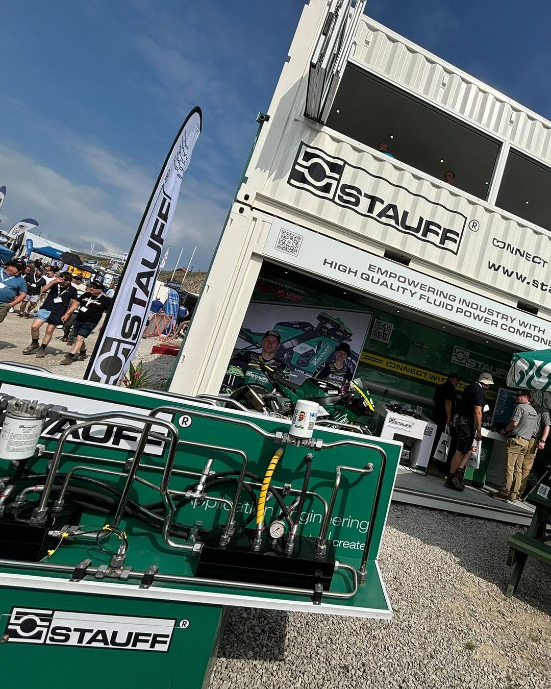 Stauff branded custom build shipping container conversion activation for hillhead 2024 with enclosed viewing area and bi-fold windows