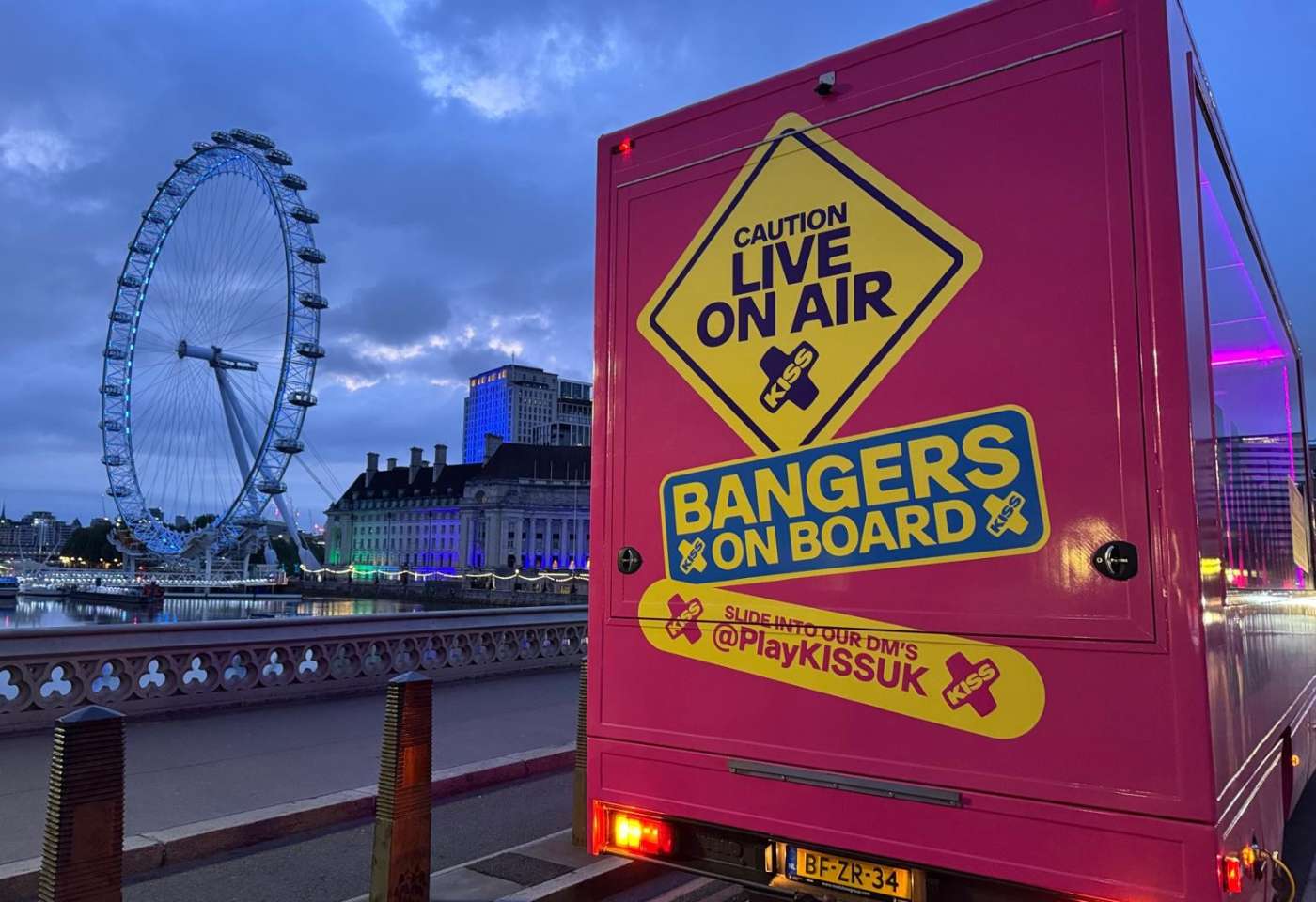Branded Kiss Radio roadshow vehicle wrapped in pink branding during a London activation