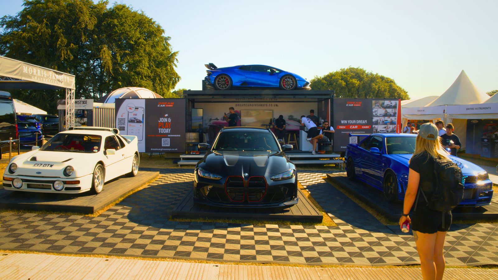 Dream Car Giveaways activation at Goodwood Festival of Speed featuring a Ferrari displayed above a customised event structure.