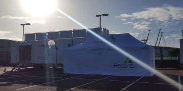 Accora Enterprise exhibition trailer on roadshow truck location with pop-up branded tent