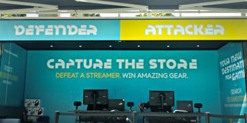 EE Gaming experiential marketing brand activation for PR stunt 'capture the moment', with two gaming stations for opponents to go head-to-head to win prizes, outside Westfield White City shopping centre in London