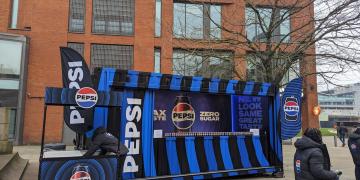 Pepsi shipping container conversion brand activation for high street product sampling campaign, handing drink samples to passersby