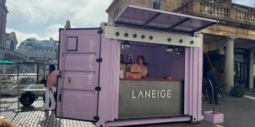 front view of 10ft container with roller door open forming serving counter and branded canopy 
