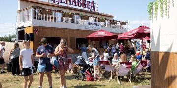 20ft shipping container bar hire at festival with branded upper deck terrace 