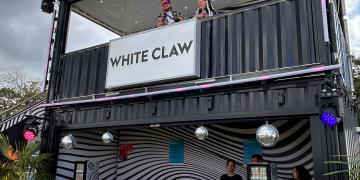shipping container bar hire with covered upper deck for branded drinks event