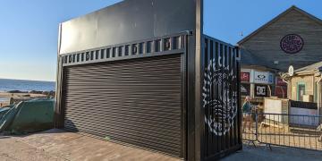 shipping container bar hire with branded setup for drinks event and activation