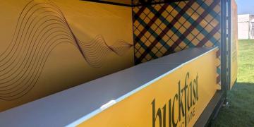 Close-up of branded container bar serving counter at festival activation
